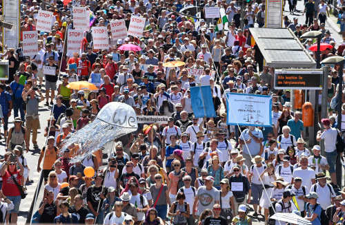 People attend a demonstration initiated by the initiative 'Querdenken-711' with the slogan 'the end of the pandemic-the day of freedom' to protest against the current measurements to curb the COVID-19 spreading in Berlin, on August 1, 2020.