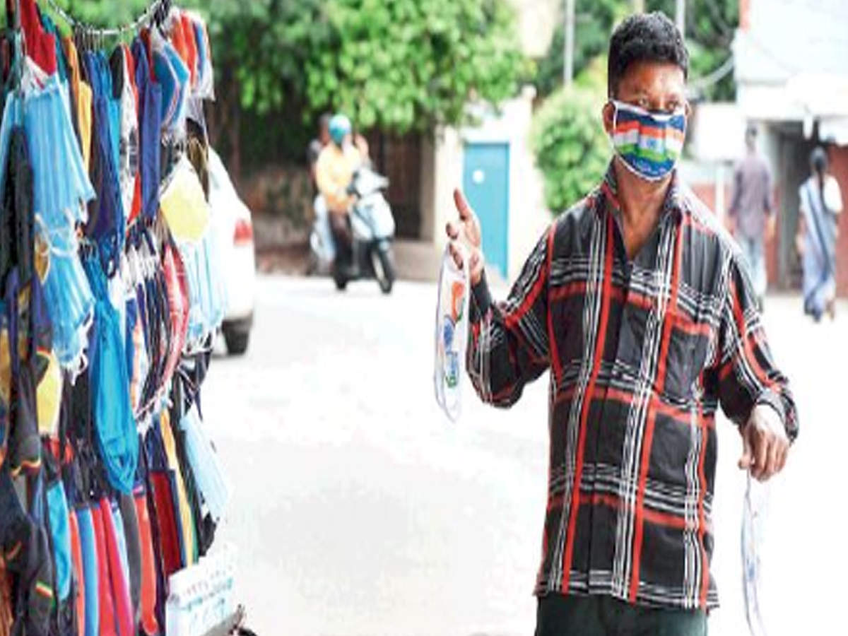 A vendor sells masks printed with national colours in the city on Tuesday ahead of Independence Day