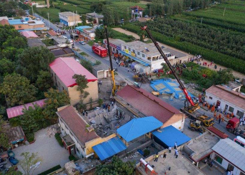 This aerial view shows rescuers searching through the rubble of a collapsed restaurant in Linfen, in China's northern Shanxi province. 