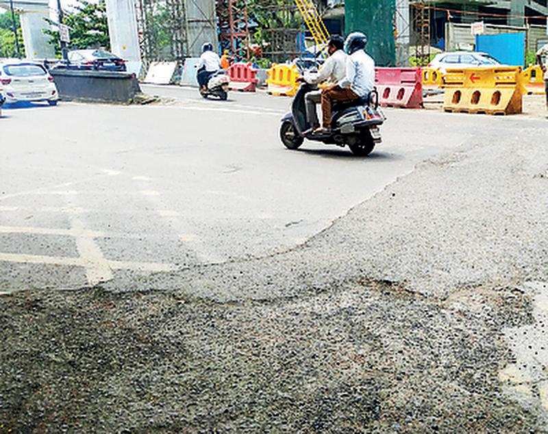 A crater on the road next to a Metro project site
