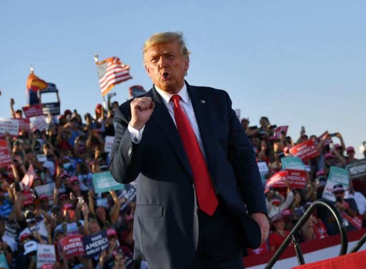 US President Donald Trump gestures at the end of a rally at Tucson International Airport in Tucson, Arizona on October 19, 2020 (AFP)