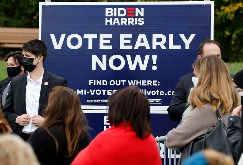 Early voting signs are seen during Democratic Vice Presidential Nominee Senator Kamala Harris (D-CA) campaign stop at the Troy Community Center on October 25, 2020 in Troy, Michigan (AFP)