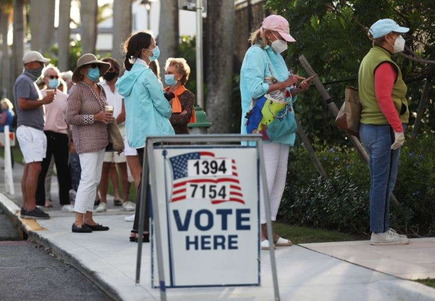People stand in line to vote at the Morton and Barbara Mandel Recreation Center on November 03, 2020 in Palm Beach, Florida (AFP)