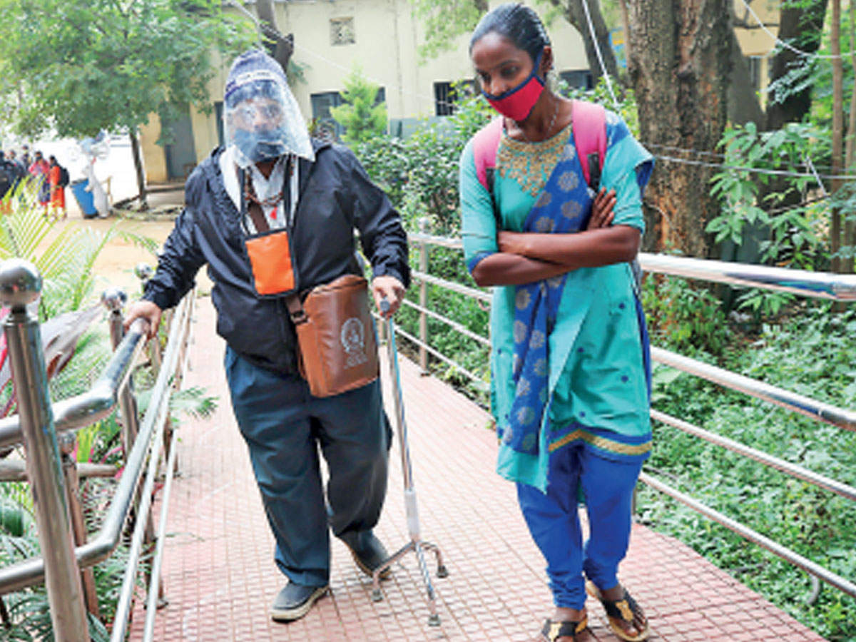 A professor (left) arrives with a student for a class at Maharani College for Women in Bengaluru