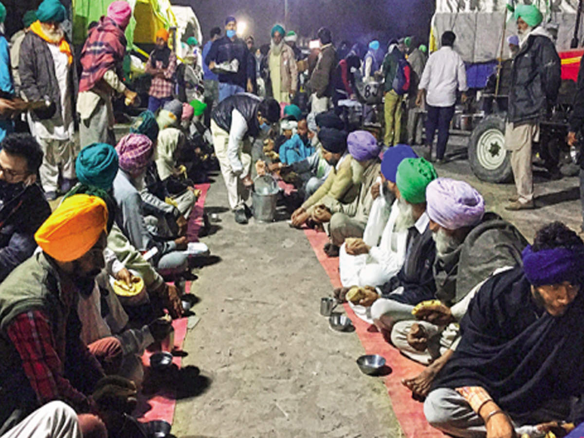 Farmers get together for a meal at Nirankari Samagam ground in Burari