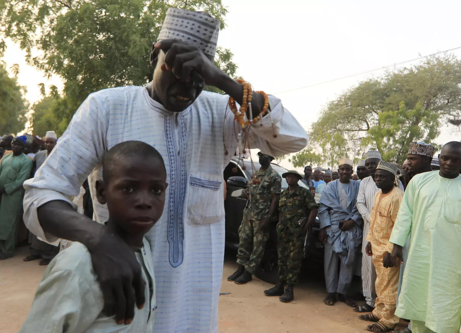 A man gestures as he receives his son, who had been rescued by the Nigerian security forces in Katsina, Nigeria, December 18, 2020. (Reuters photo)