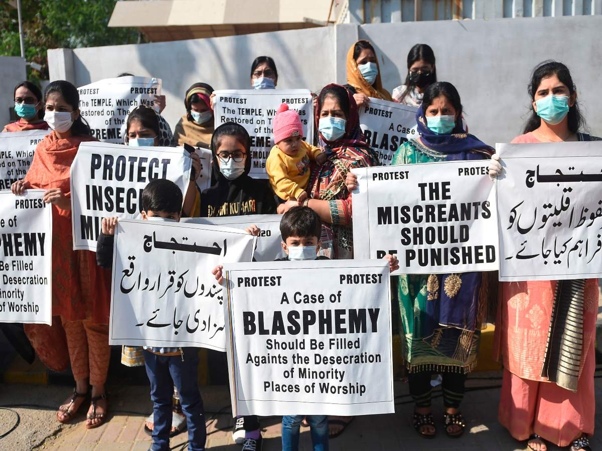 Members of Pakistan Hindu Council hold placards during a protest in Karachi, Pakistan in Dec 2020. (Credits: AFP)