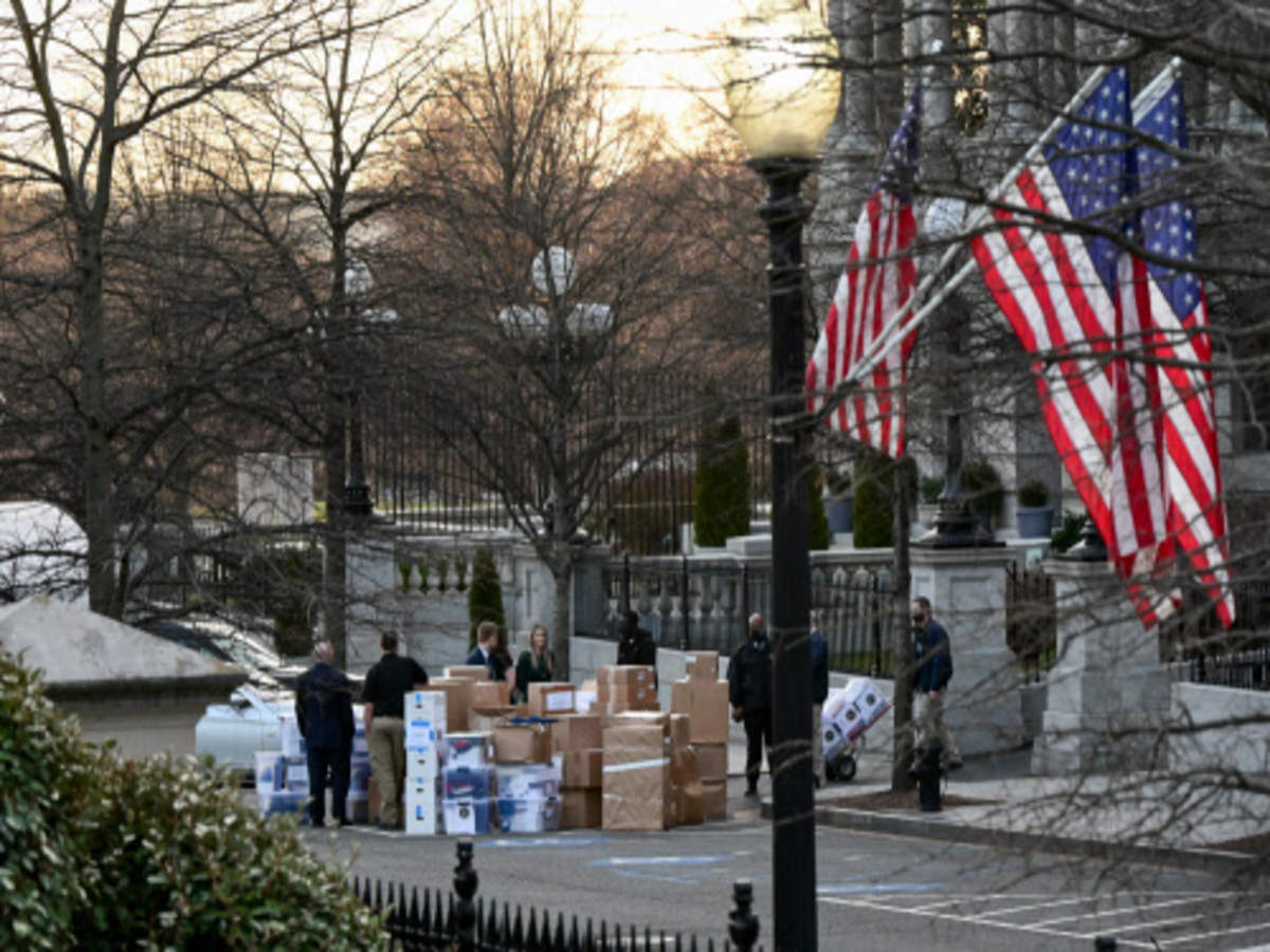 Workers move boxes out of the Eisenhower Executive Office Building on the White House grounds in Washington, US