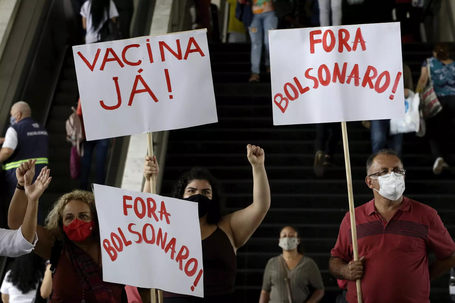 FILE - In this Dec. 23, 2020 file photo, "Vaccine now!" and "Get out Bolsonaro," in a protest against Brazilian President Jair Bolsonaro's handling of the new coronavirus pandemic, in Brasilia, Brazil.  
