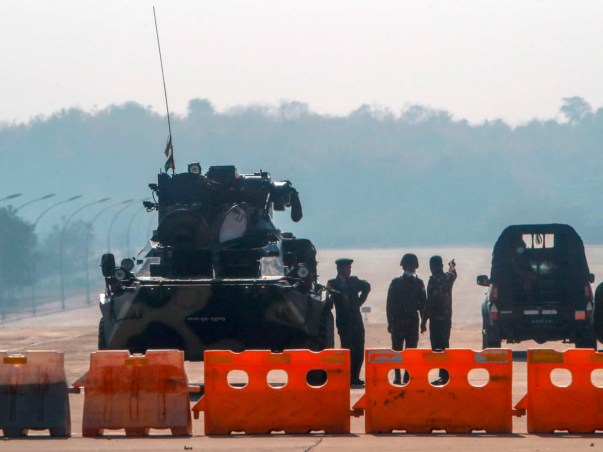 Myanmar's military stand guard at a checkpoint manned with an armored vehicle in a road leading to the parliament building in Naypyitaw, Myanmar (AP)