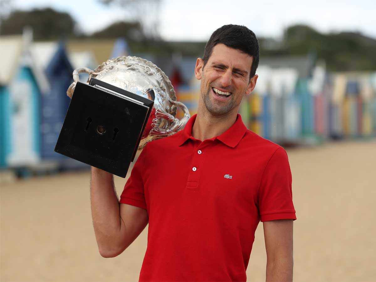 Parading his trophy on the beach in the Melbourne suburb of Brighton, Novak Djokovic said a second scan of his abdomen had revealed he had made the injury worse by playing on (Getty Images)