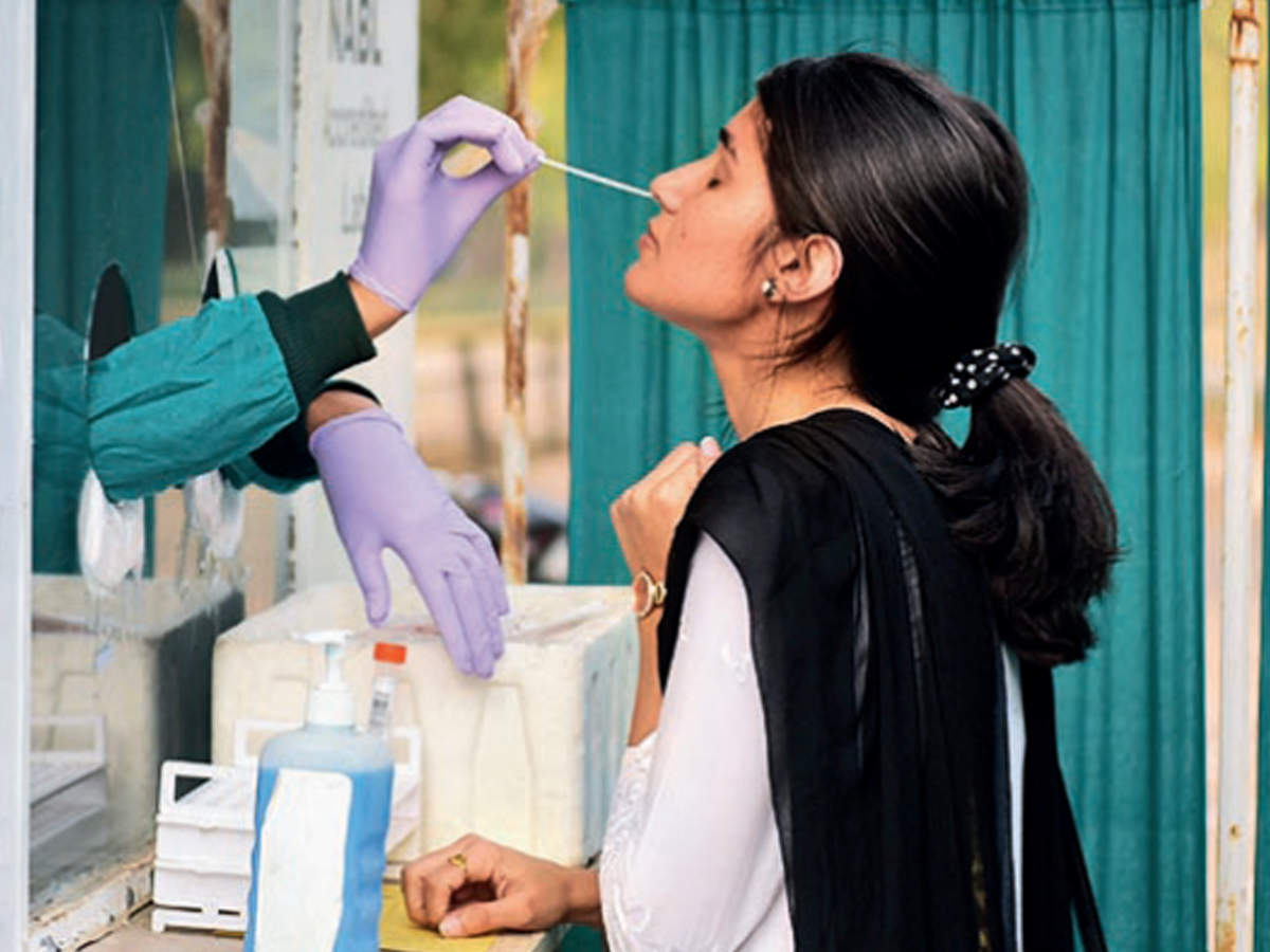 A girl gives swab for testing opposite Sector 10 museum 