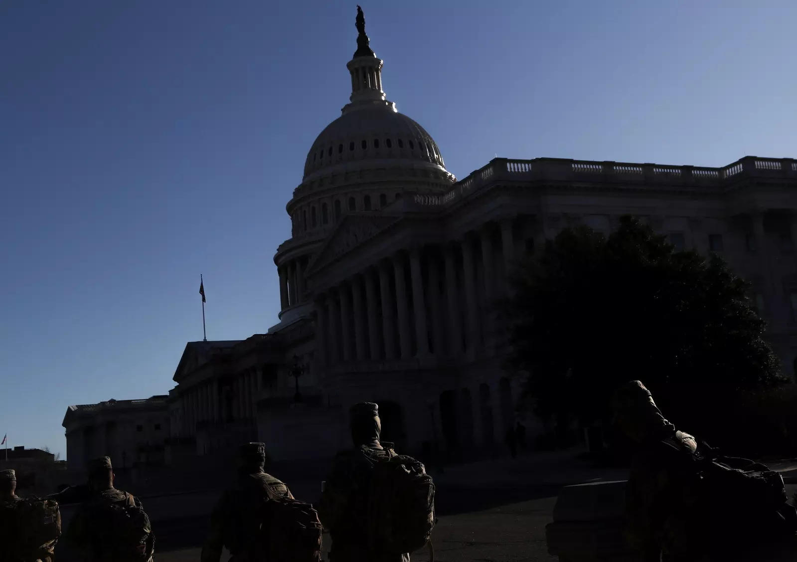 Members of the US National Guard walk towards the US Capitol Building amid heightened security