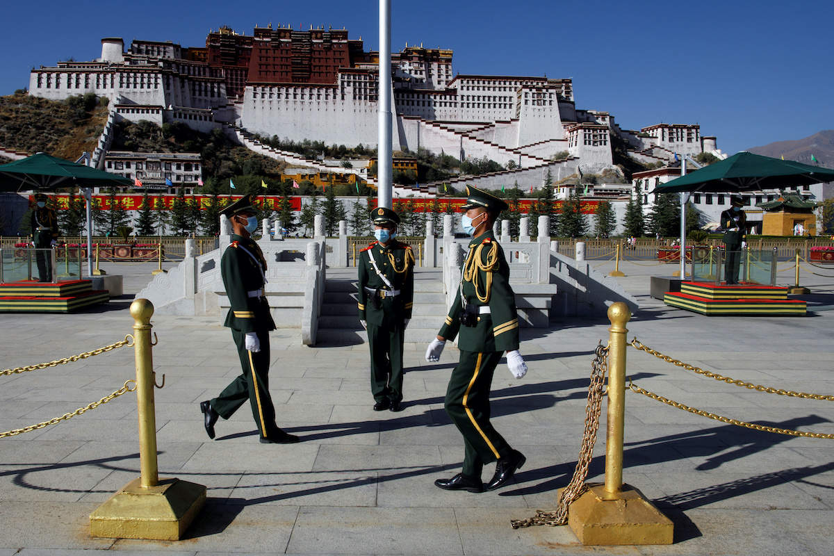 Paramilitary police officers swap positions during a change of guard in front of Potala Palace in Lhasa. (File photo for representation purpose only)