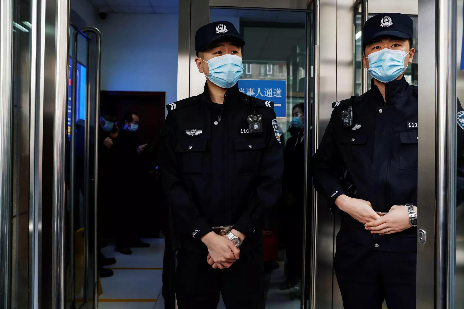 Police officers stand guard at an entrance of Beijing No. 2 Intermediate People's Court where Michael Kovrig, a Canadian detained by China in December 2018 on suspicion of espionage, is expected to stand trial, in Beijing 