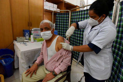 A medical worker inoculates a man with the dose of  coronavirus vaccine in Chandigarh 