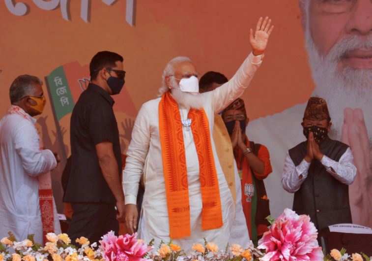 PM Narendra Modi  waves to supporters in a rally meeting during the ongoing Phase 4 of West Bengal's assembly election, at Kawakhali on the outskirts of Siliguri (AFP)