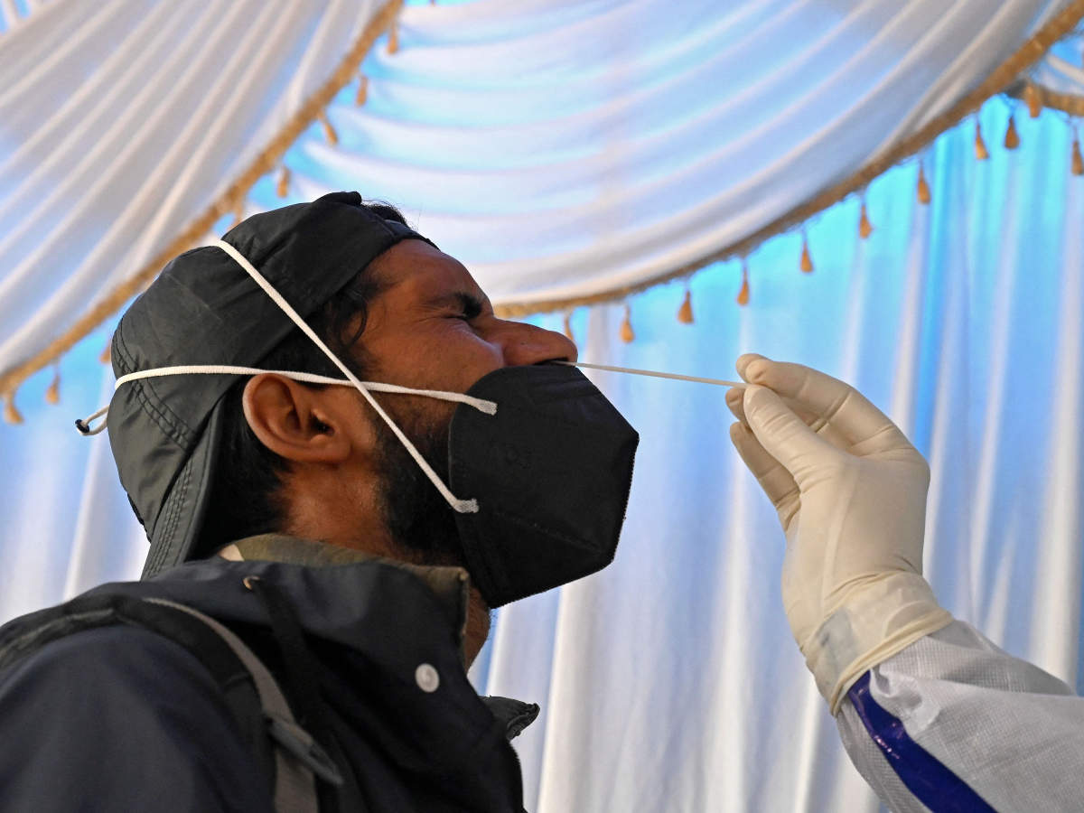 A health worker takes nasal swab samples from people to test for the Covid-19 coronavirus infection at a testing center in Srinagar on April 15, 2021 (AFP)