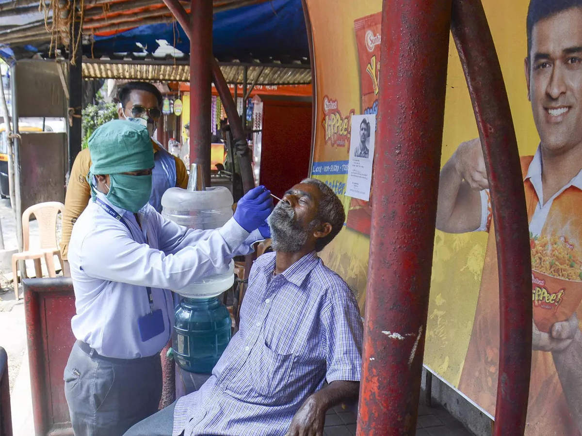 A medic takes swab sample from a person for Covid-19 test amid surge in coronavirus cases, in Thane