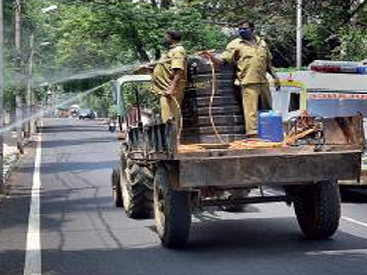 BBMP workers spray disinfectant on KR Road in Bengaluru on Tuesday to control the spread of the virus.