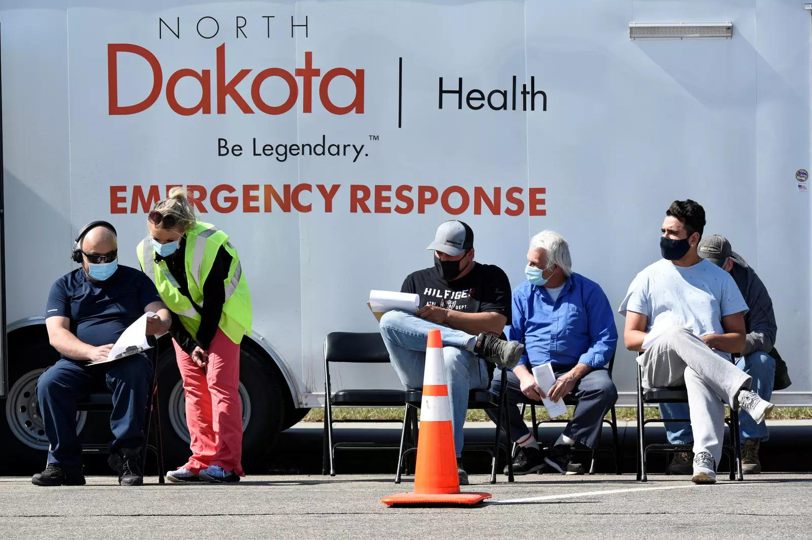 People rest in chairs after being vaccinated against coronavirus disease at a rest stop near Drayton, North Dakota.