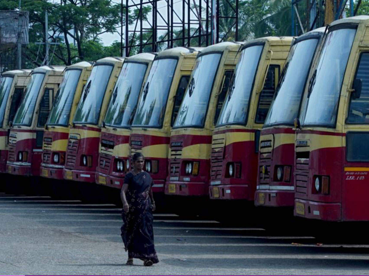 A passenger walks past the parked buses during a lockdown. (Photo by Arunchandra BOSE / AFP)