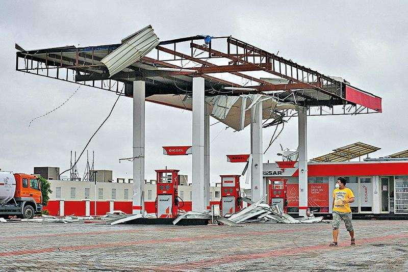 A damaged fuel station after the impact of Cyclone Tauktae near Amreli on Tuesday