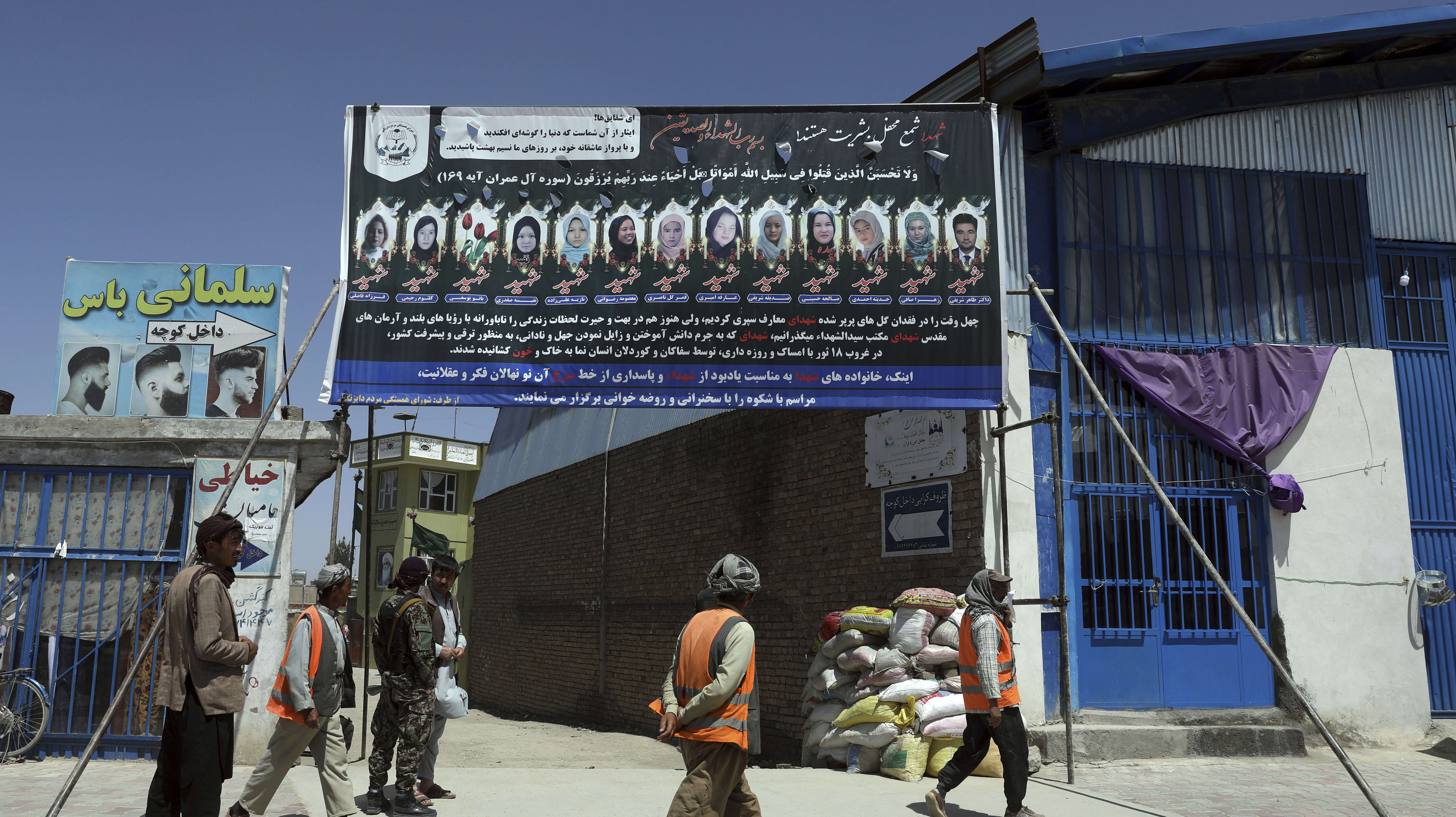 Photographs of killed students of Syed Al-Shahada School are displayed on the gate of a mosque in Dasht-e-Barchi neighborhood of Kabul, Afghanistan, Tuesday, June 1, 2021. (AP image)