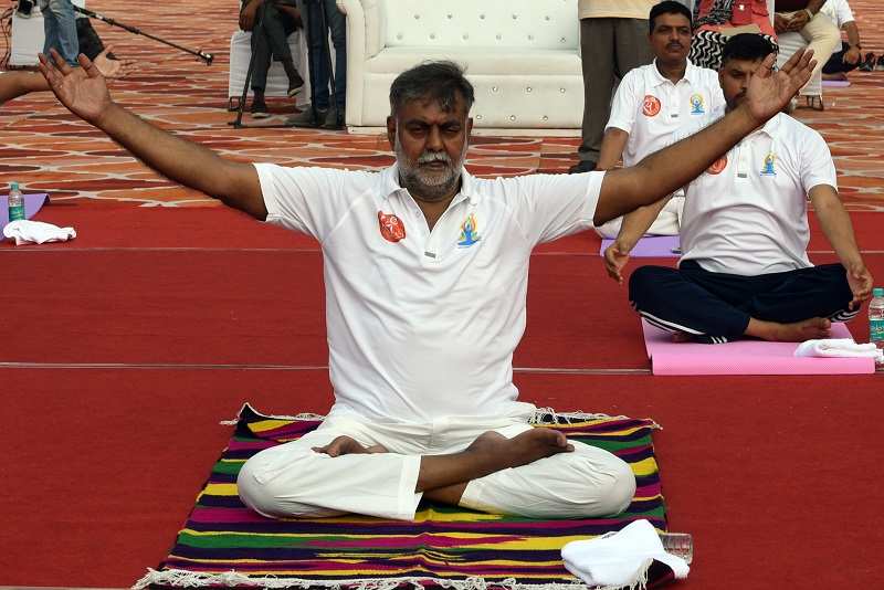 Culture and tourism minister Prahlad Singh Patel performing yoga with others on International Day of Yoga at Red Fort in New Delhi on June 21.