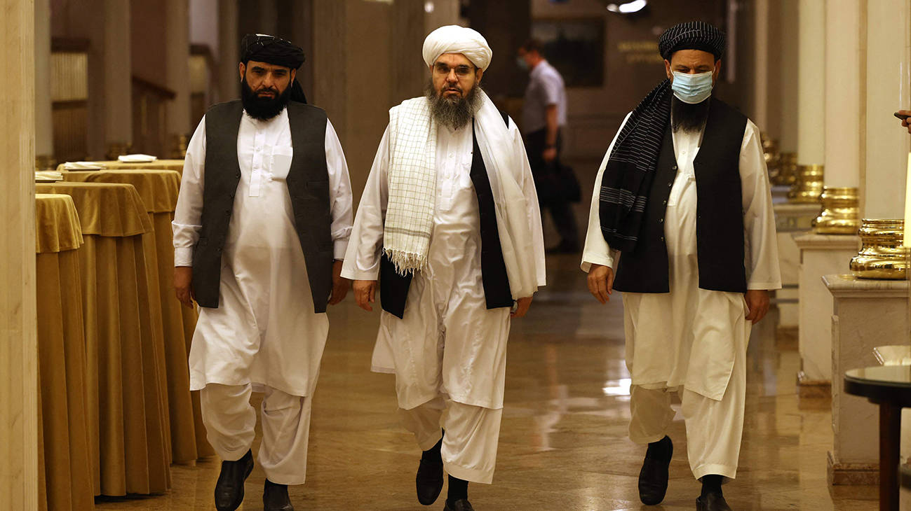 Leaders of the Taliban movement walk to attend a press conference in Moscow. (Photo Credit: AFP)