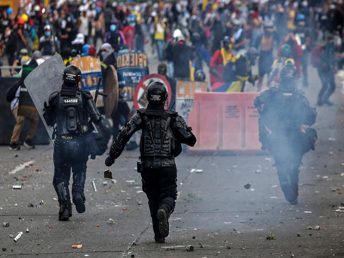 Demonstrators clash with riot police during a protest against the government of Colombian President Ivan Duque in Cali, Colombia on July 20, 2021, amid Independence Day celebrations in the country. (AFP)