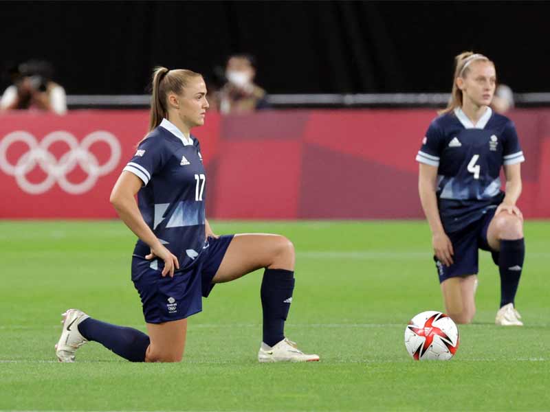 Britain's Georgia Stanway (left) and Keira Walsh take a knee before the Tokyo Olympics women's group E first round football match against Chile. (AFP Photo)