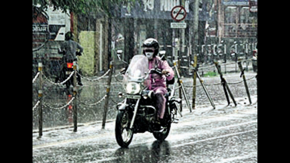 A biker rides through rain in Guwahati on Friday