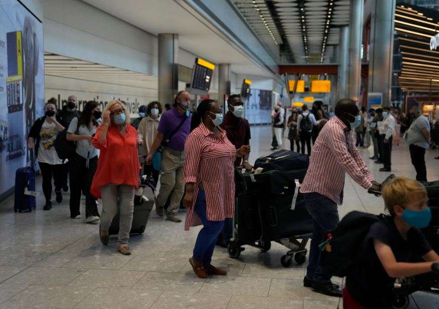 Passengers arrive at Terminal 5 of Heathrow Airport in London (AP)