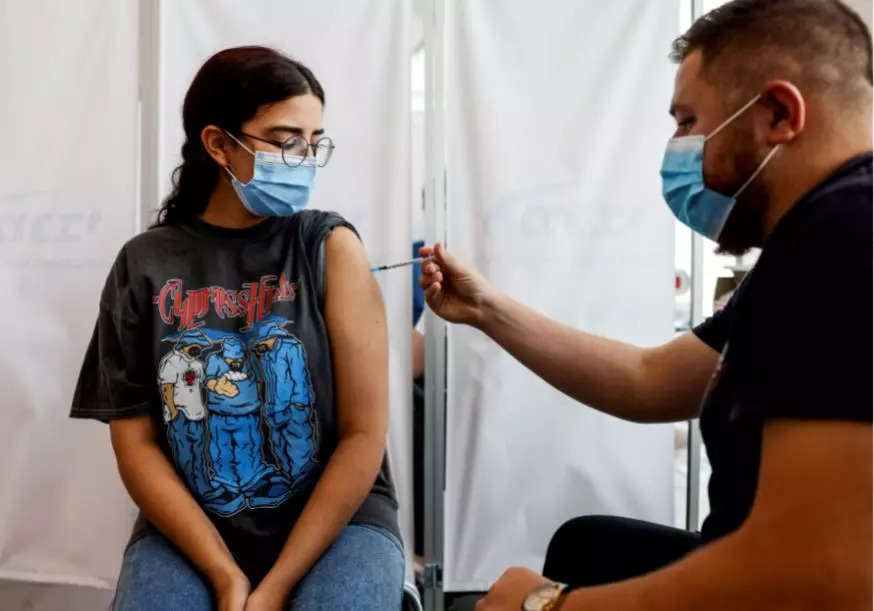 An Israeli woman receives a third shot of coronavirus disease (Reuters)