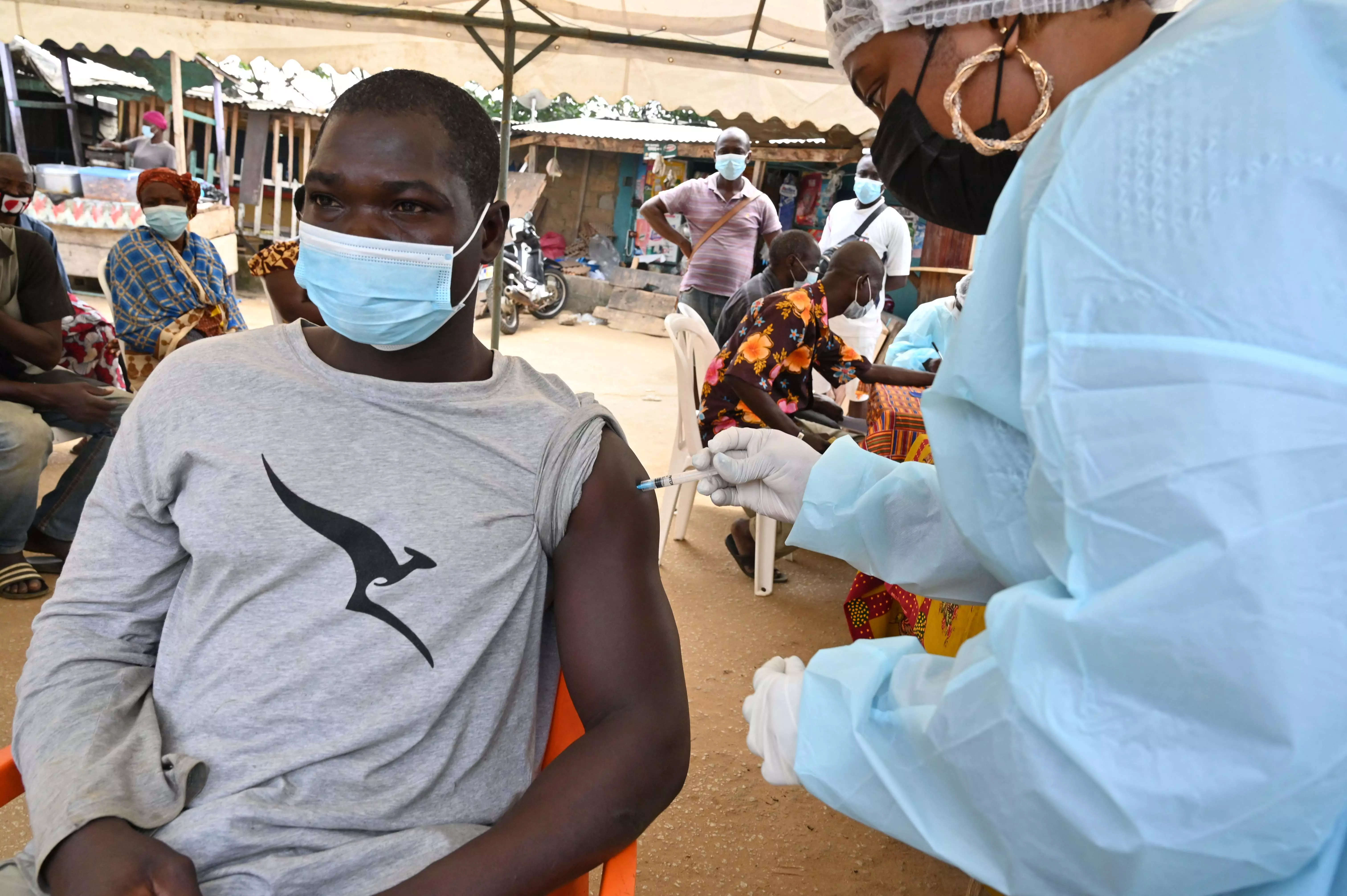 A health worker vaccinates a man in Abidjan on August 17, 2021 during a roll-out of vaccinations against Ebola on August 17, 2021. (AFP)