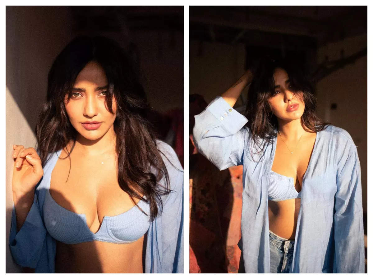 Neha Sharma ups the hotness quotient as she slips into a blue bralette and an unbuttoned shirt! Malayalam Movie News pic