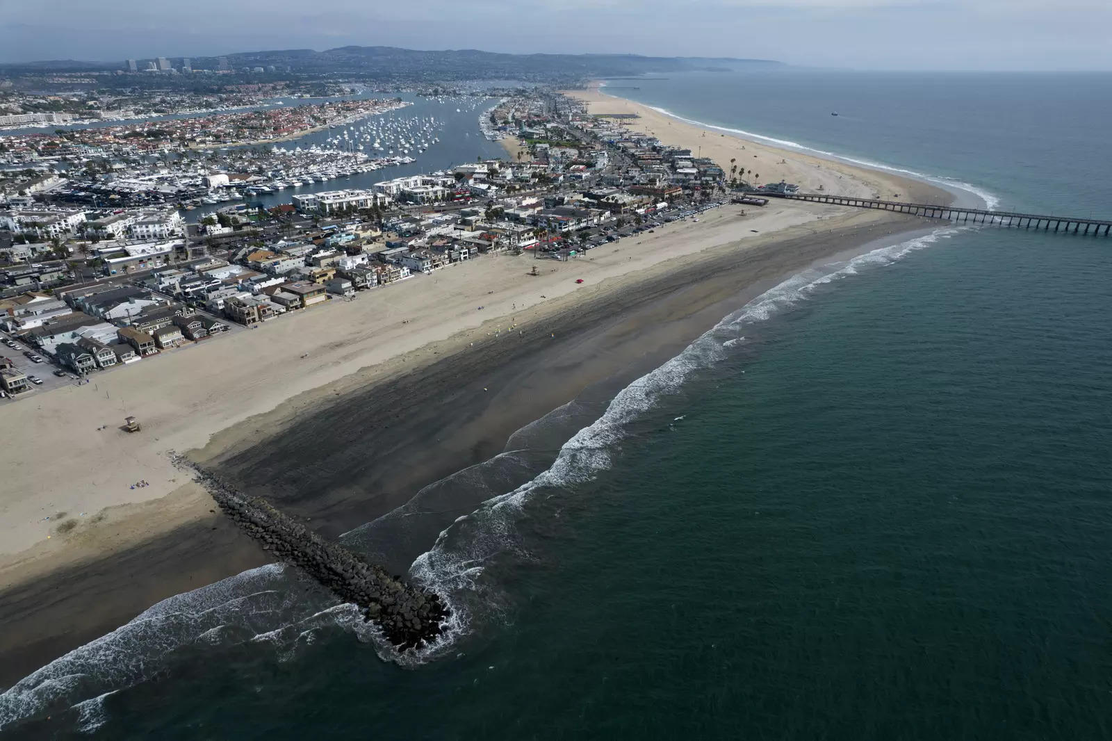 An aerial photo shows the closed beach after oil washed up on a beach in Newport Beach, California