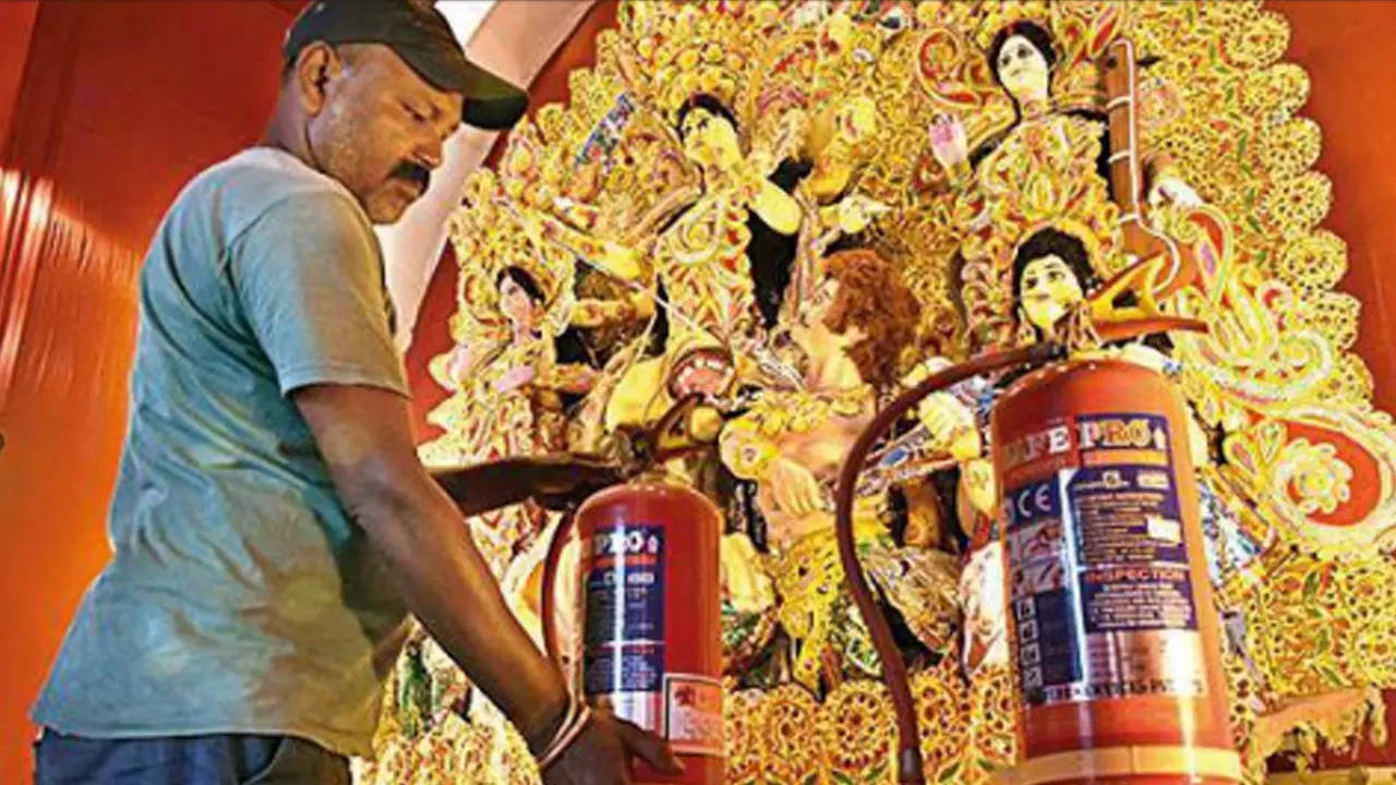 A man inspects fire extinguishers at a Puja pandal in Ranchi on Sunday 