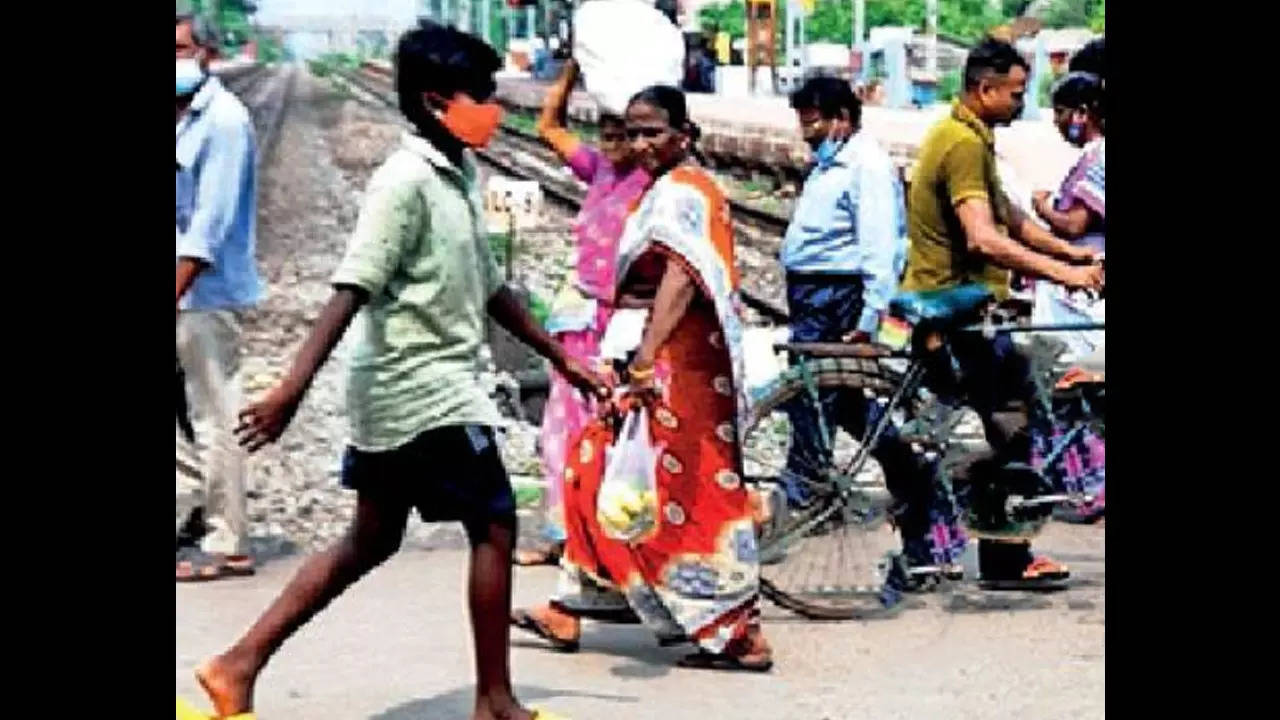 Daily grind: Passengers near the Wimco Nagar Railway station have to cross tracks and walk to the metro station