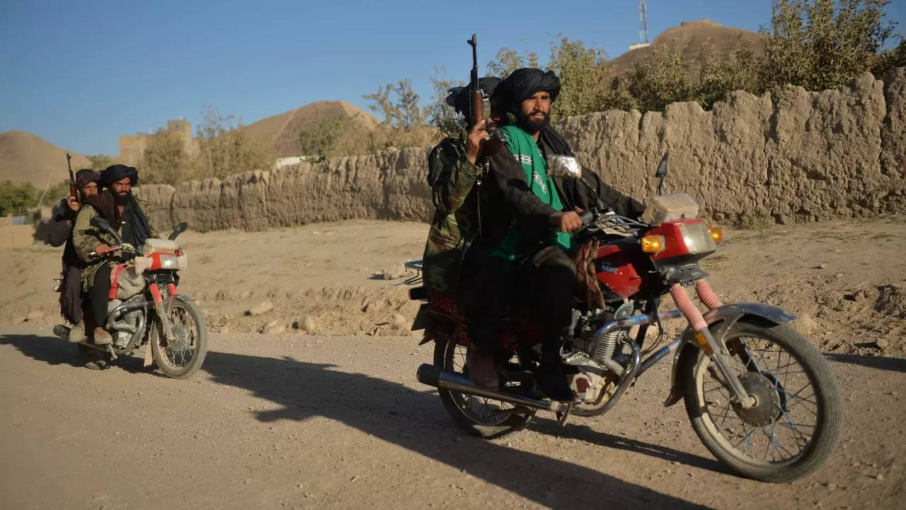 Taliban fighters patrol along a road on motorbikes at Ghasabha area in Qala-e-Now. (AFP photo)