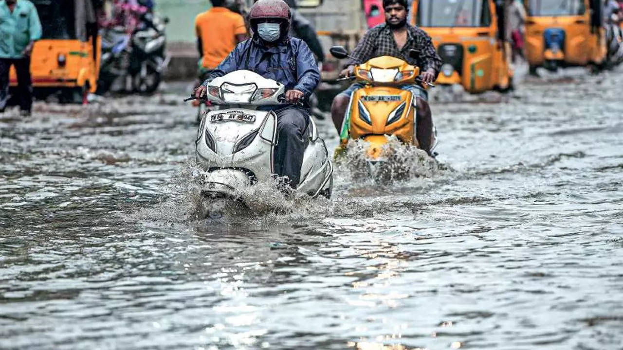  In Peravallur, motorists manoeuvre a flooded stretch