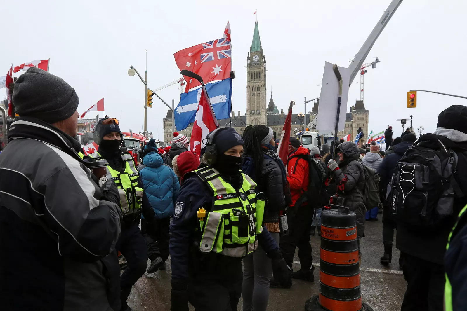 Police officers walk through protest crowd in front of the Parliament Hill, as truckers and supporters continue to protest coronavirus disease (Covid-19) vaccine mandates, in Ottawa, Ontario, Canada.