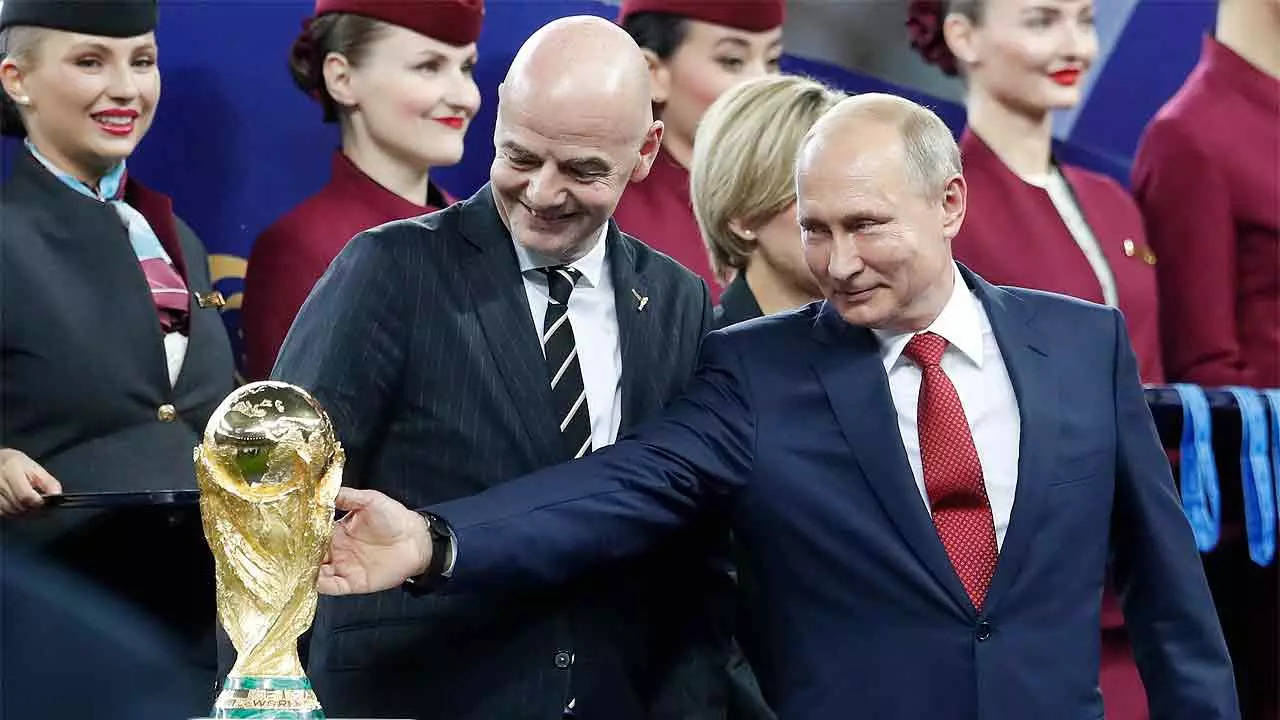 Vladimir Putin touches the World Cup trophy during the 2018 FIFA World Cup in the Luzhniki Stadium in Moscow. (AP Photo)
