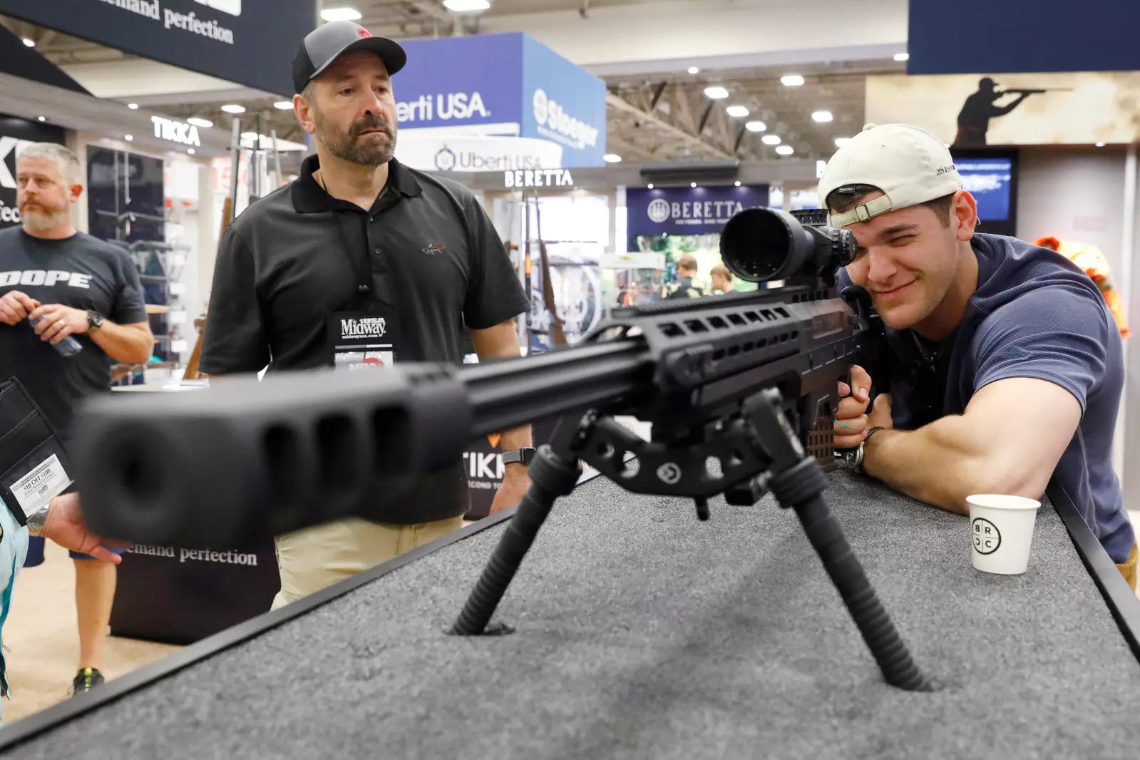 A man looks through a .50 caliber rifle during the annual National Rifle Association (NRA) convention in Dallas, Texas (Reuters file photo)