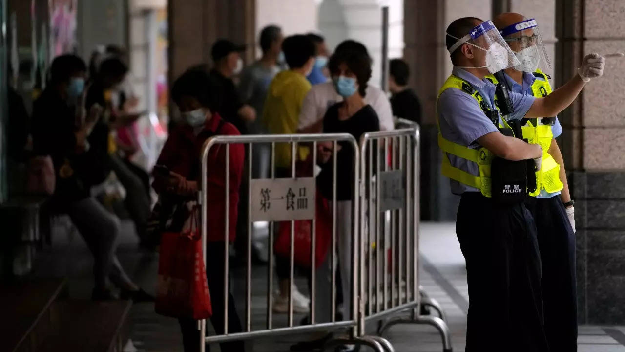 Police officers wearing masks and face shields keep watch outside a shopping mall, after the Covid lockdown was lifted in Shanghai, on Wednesday. (Reuters photo)