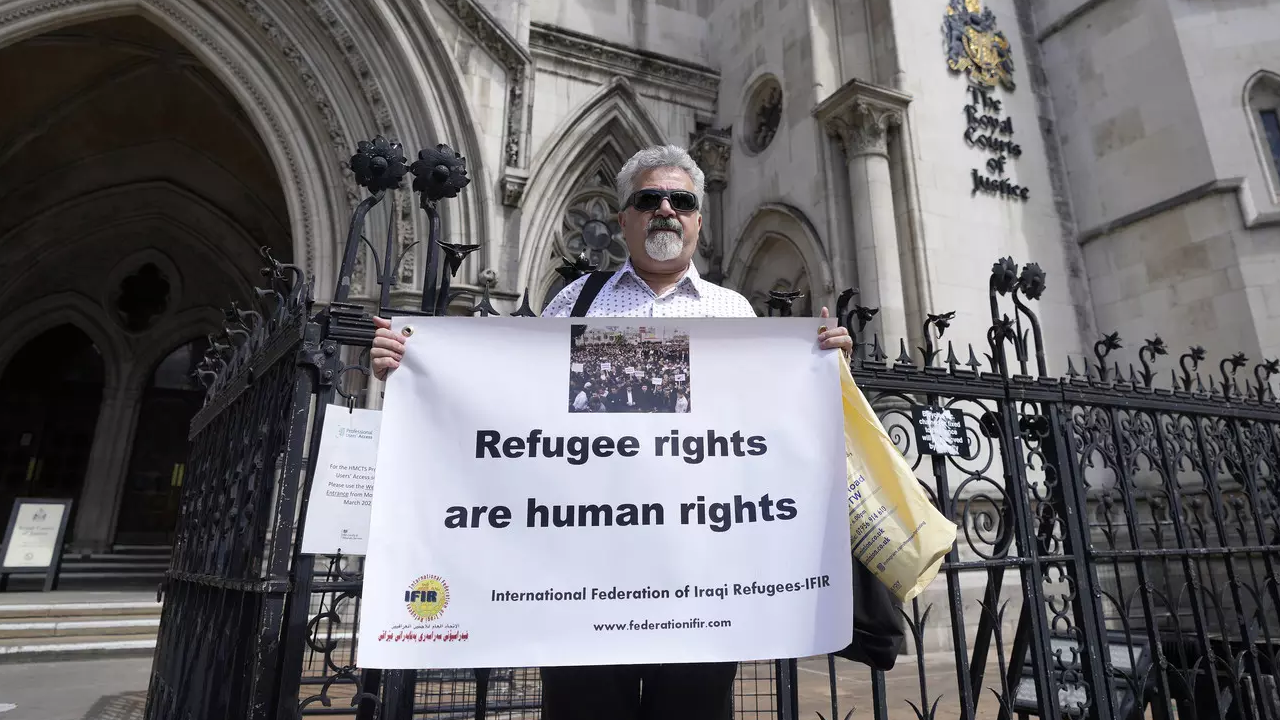 Protestors stand outside The Royal Court of Justice in London. (AP Photo)