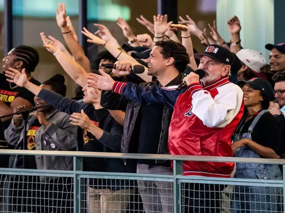 Fans sing Sweet Caroline during an NFL football game between the