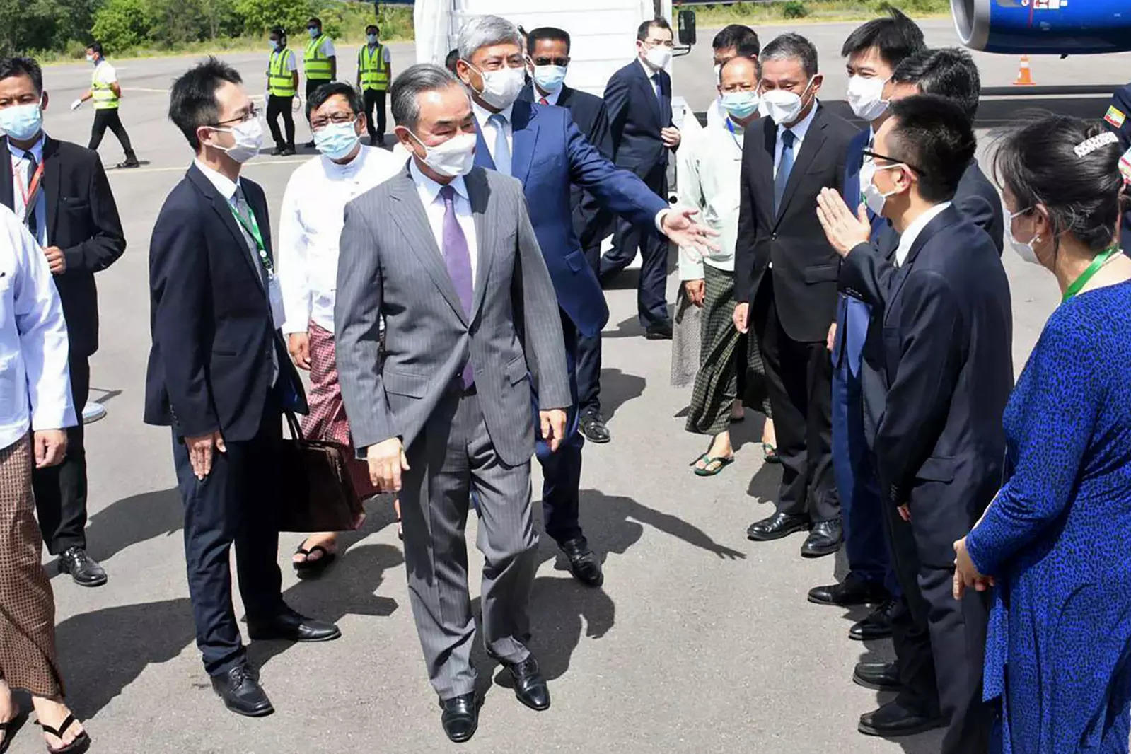 Chinese foreign minister Wang Yi (centre) is welcomed by Myanmar Foreign Ministry representatives and Chinese embassy officials upon his arrival at Nyaung Oo Airport in Bagan, Myanmar, Saturday July 2, 2022. (File photo: AP)