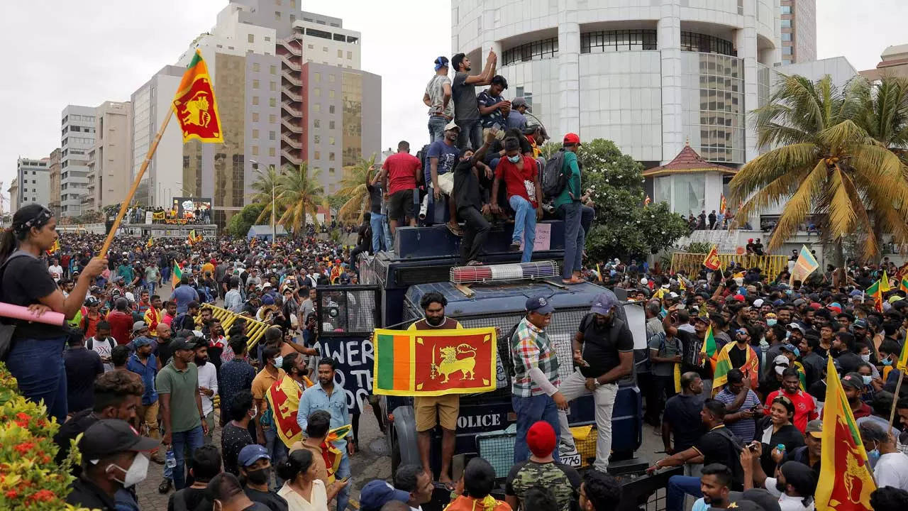 Demonstrators protest on top of a police tear gas truck after entering the Presidential Secretariat premises in Colombo. (Reuters)